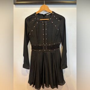 Semi-sheer black dress with a-line flare and lace trim.